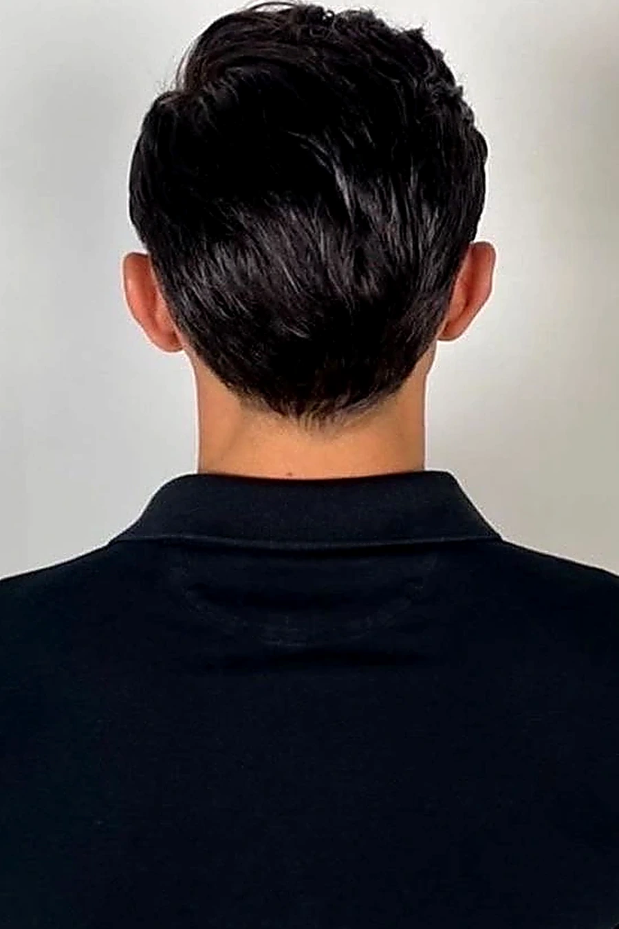 Full view of the back of a finished natural-looking men's hairstyle
